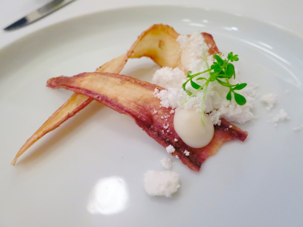 Amuse Bouche parsnip root chip with cauliflower and chicken fat 