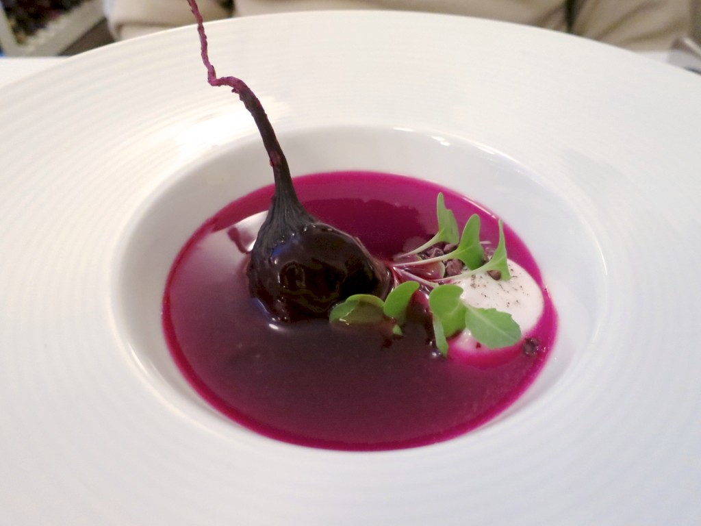 Beet Soup warm beet consommé, baby beets, goat milk, cabbage chip and red cabbage puree and cocoa nib